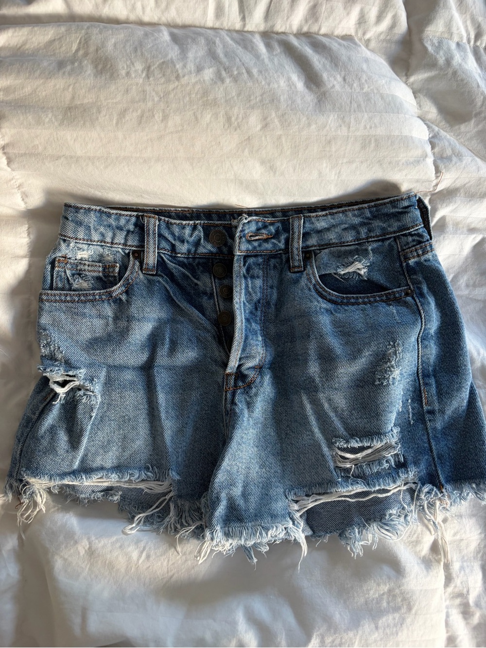 High-Rise Distressed Denim Jean Shorts in Light Blue